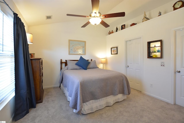 bedroom featuring light carpet, multiple windows, vaulted ceiling, and visible vents