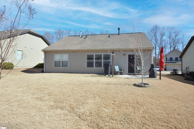 rear view of house featuring a yard