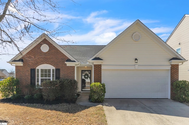 ranch-style home featuring an attached garage, driveway, a shingled roof, and brick siding