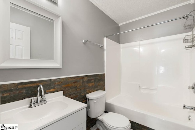 bathroom featuring tub / shower combination, a textured ceiling, toilet, and vanity