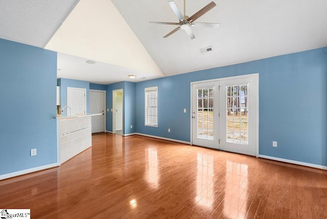 unfurnished room with high vaulted ceiling, a ceiling fan, baseboards, and wood finished floors