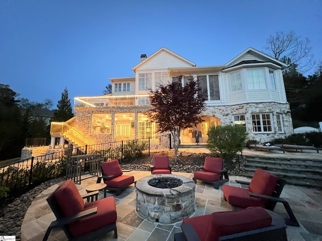 view of patio with fence and a fire pit