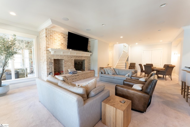 living room with crown molding, a fireplace, recessed lighting, light colored carpet, and stairway