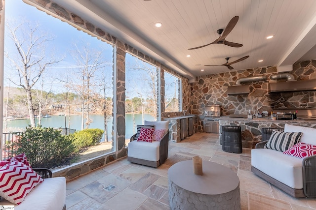 interior space featuring a water view, an outdoor hangout area, a ceiling fan, and area for grilling