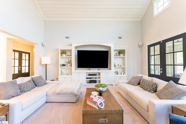 living room with high vaulted ceiling, french doors, and visible vents