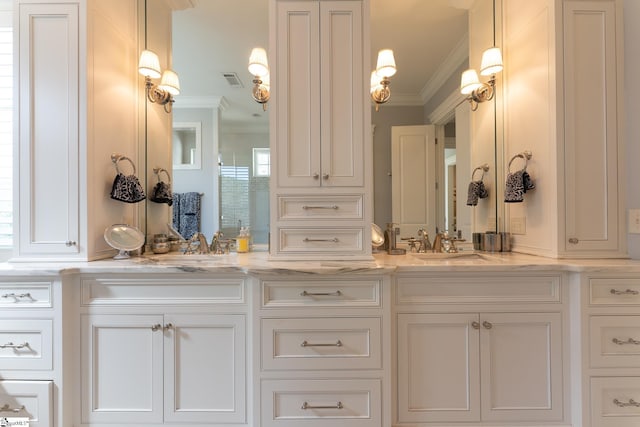 full bath featuring a sink, double vanity, visible vents, and crown molding