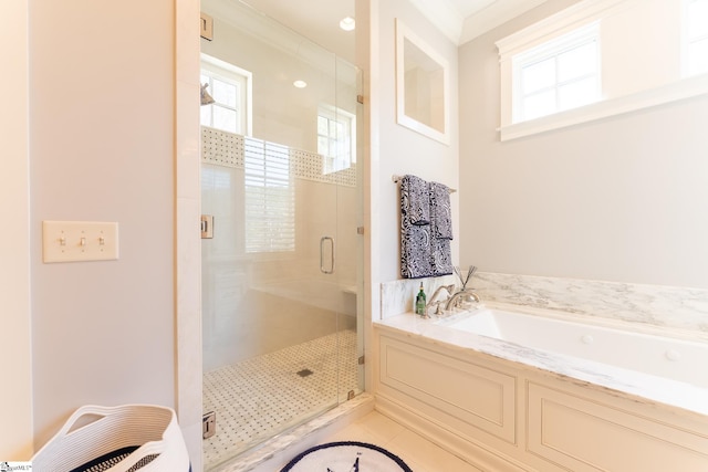 full bathroom with a garden tub, tile patterned floors, crown molding, and a stall shower