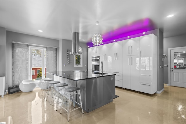 kitchen featuring finished concrete floors, modern cabinets, white cabinetry, and stainless steel double oven