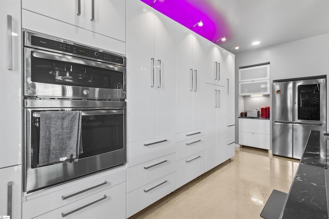 kitchen with concrete floors, white cabinets, appliances with stainless steel finishes, open shelves, and modern cabinets