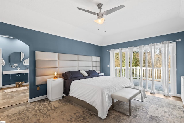 bedroom with a ceiling fan, access to outside, vaulted ceiling, and baseboards