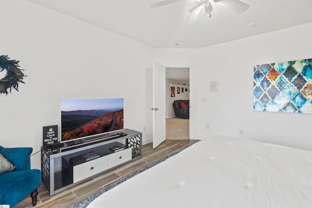 bedroom featuring wood tiled floor and ceiling fan