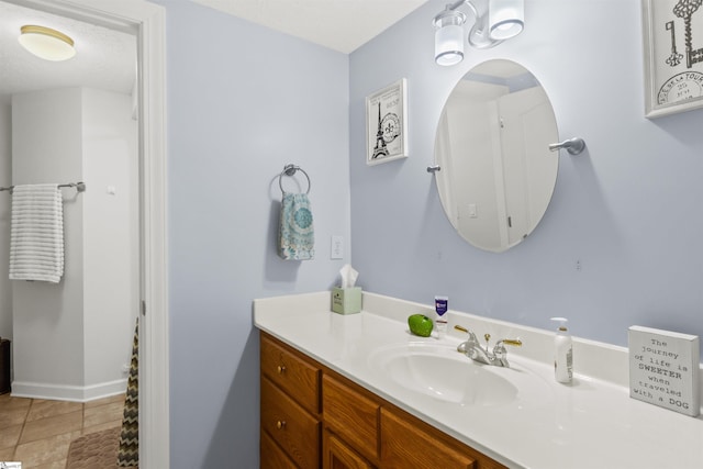 bathroom with baseboards and vanity