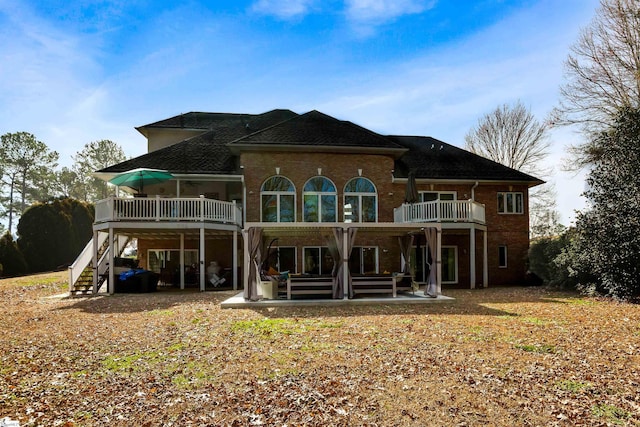 back of house with a patio area, brick siding, stairway, and a wooden deck