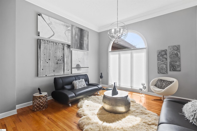 living area featuring baseboards, crown molding, a chandelier, and wood finished floors