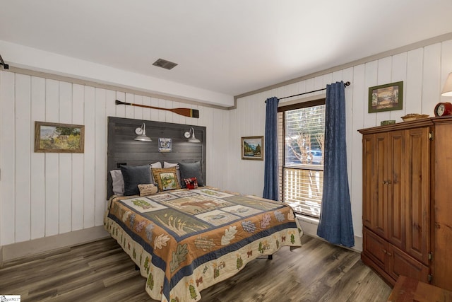 bedroom with dark wood-style flooring and visible vents