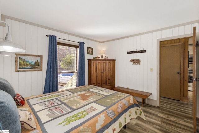 bedroom with wood finished floors and crown molding