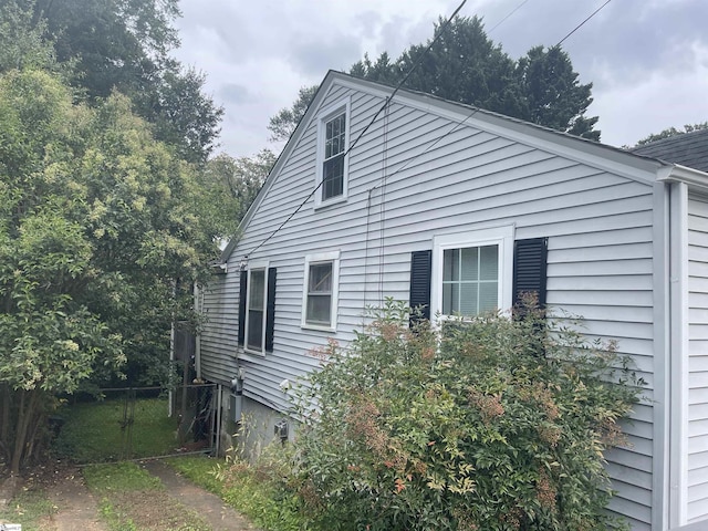 view of side of home featuring fence