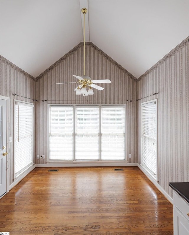 unfurnished dining area featuring light wood-type flooring, visible vents, and wallpapered walls