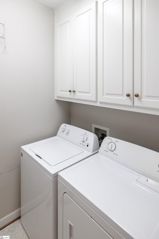 laundry room with baseboards, cabinet space, and washer and dryer