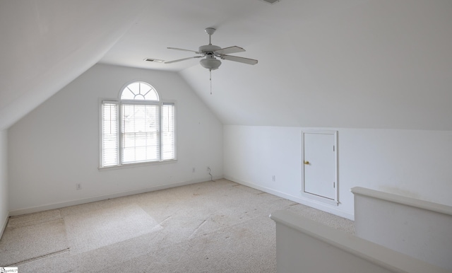 bonus room with lofted ceiling, ceiling fan, carpet floors, visible vents, and baseboards