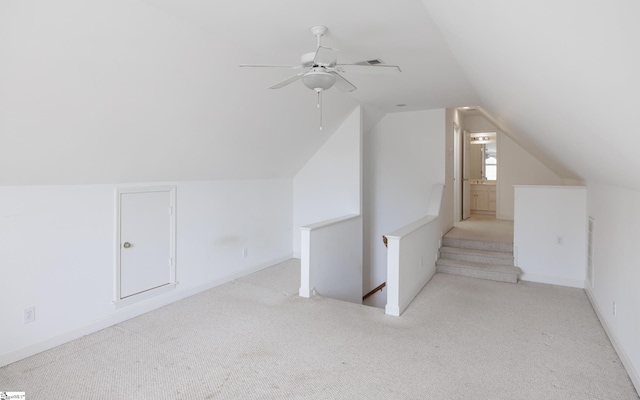 bonus room featuring a ceiling fan, lofted ceiling, carpet flooring, and baseboards