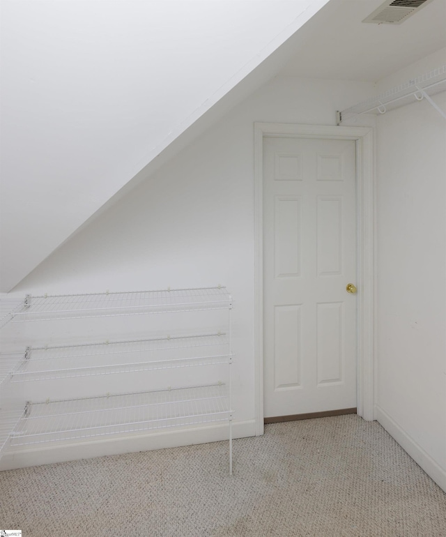 bonus room featuring light carpet, vaulted ceiling, visible vents, and baseboards