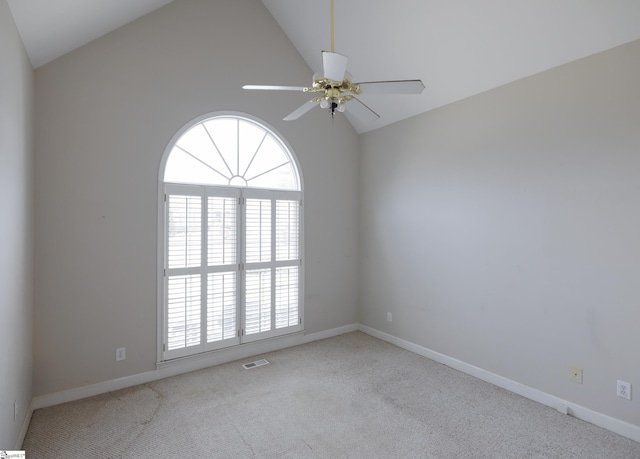 carpeted empty room featuring high vaulted ceiling, ceiling fan, visible vents, and baseboards