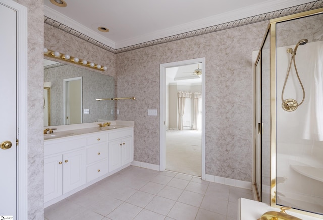 full bath with a sink, wallpapered walls, double vanity, and crown molding