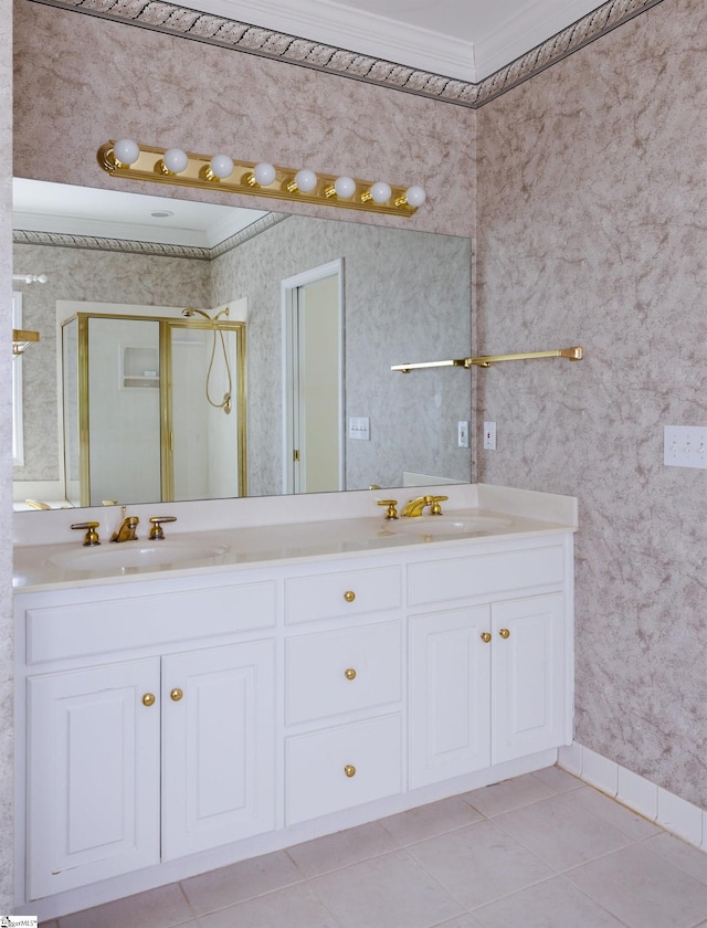 bathroom featuring double vanity, ornamental molding, a stall shower, and a sink