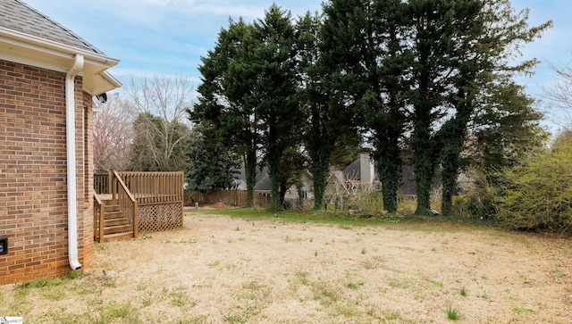 view of yard with a deck and fence