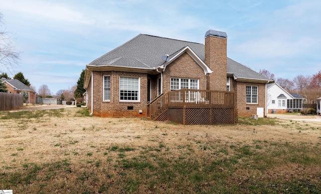 rear view of property with a shingled roof, a chimney, crawl space, a wooden deck, and brick siding