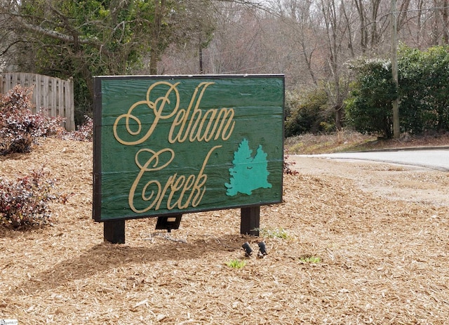 community / neighborhood sign with fence