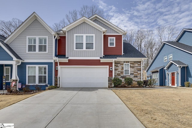 craftsman-style house with a garage, driveway, stone siding, a front lawn, and board and batten siding