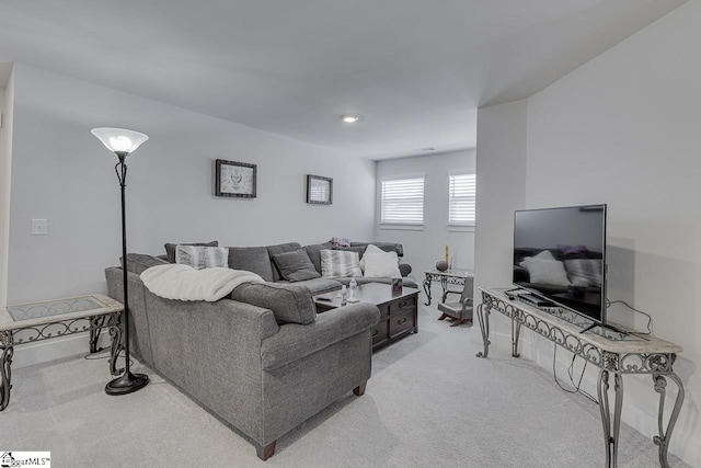 living room featuring baseboards and light colored carpet