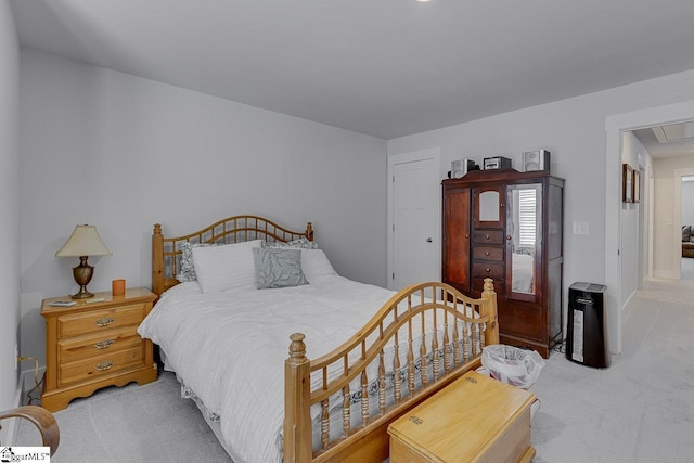 bedroom with light carpet and attic access