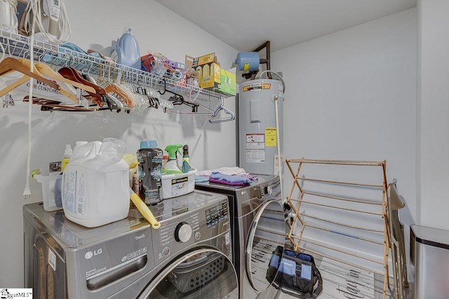 washroom with laundry area, water heater, and independent washer and dryer