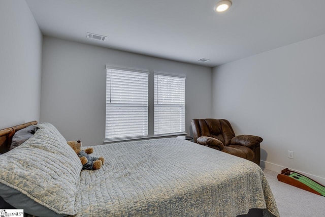 bedroom with carpet floors, visible vents, and baseboards