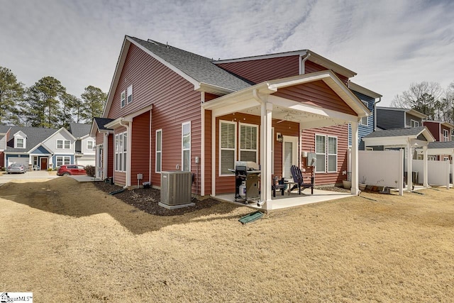 exterior space featuring a residential view, a patio area, central AC, and fence