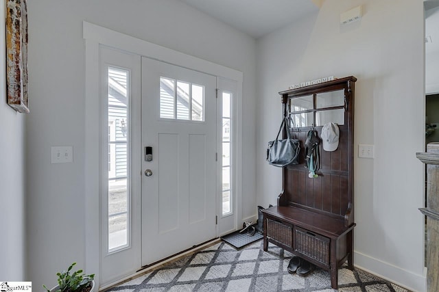 foyer entrance with plenty of natural light and baseboards