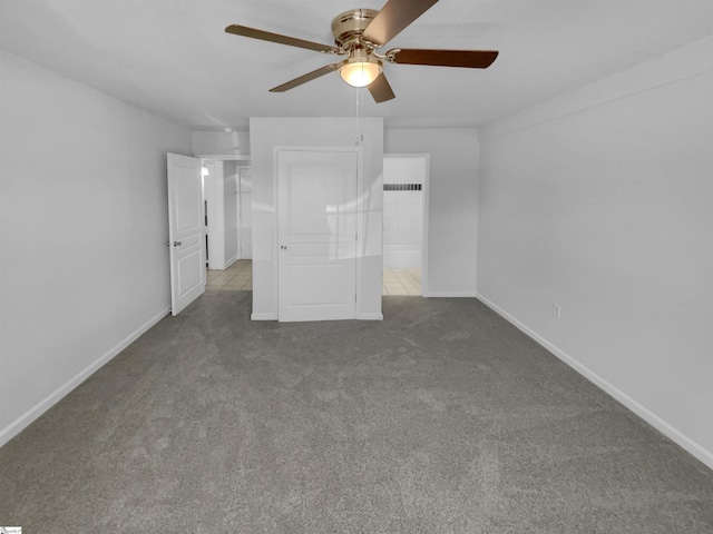 unfurnished bedroom with carpet flooring, a ceiling fan, and baseboards