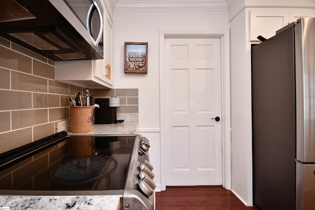 kitchen featuring crown molding, appliances with stainless steel finishes, backsplash, and white cabinets