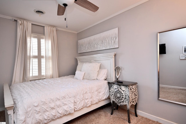 bedroom with baseboards, visible vents, a ceiling fan, ornamental molding, and carpet flooring