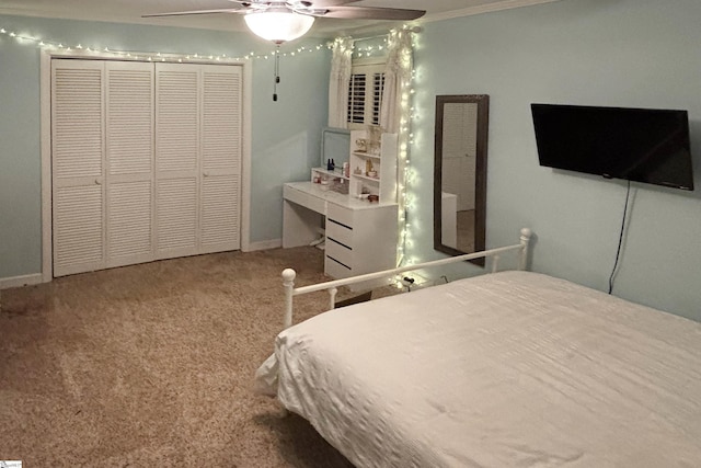 carpeted bedroom featuring ceiling fan and a closet