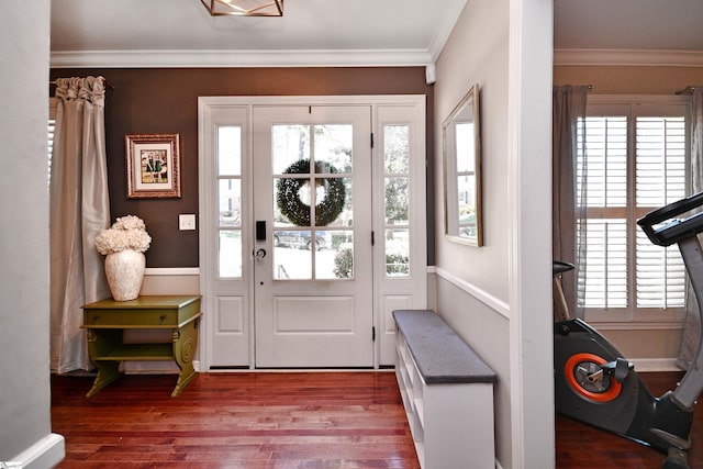 foyer entrance with wood finished floors and crown molding