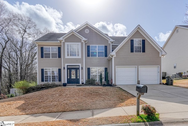 view of front of home with concrete driveway and an attached garage