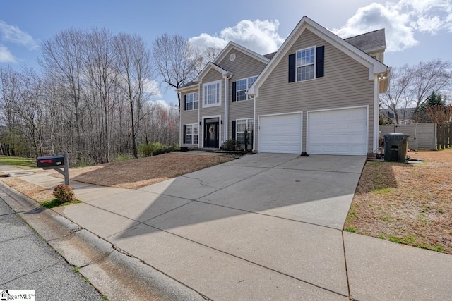 traditional-style house with a garage and concrete driveway