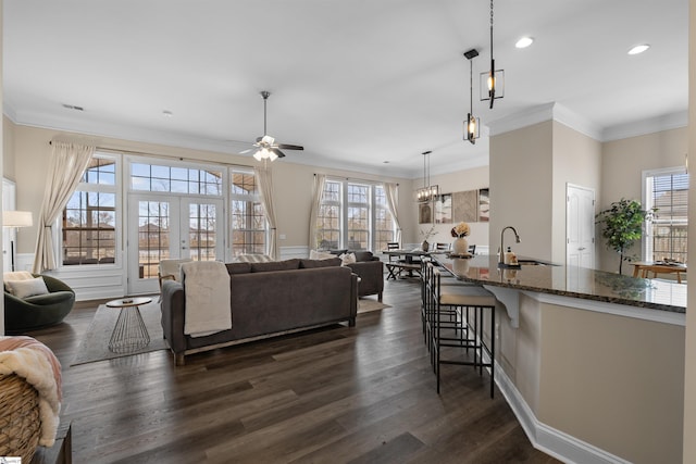 living room featuring a ceiling fan, dark wood finished floors, recessed lighting, french doors, and crown molding