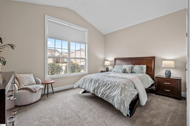 carpeted bedroom featuring baseboards and vaulted ceiling