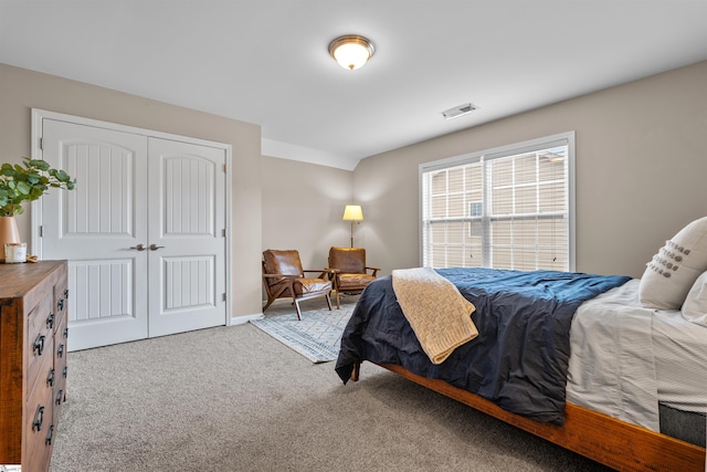 bedroom featuring a closet, baseboards, visible vents, and carpet floors