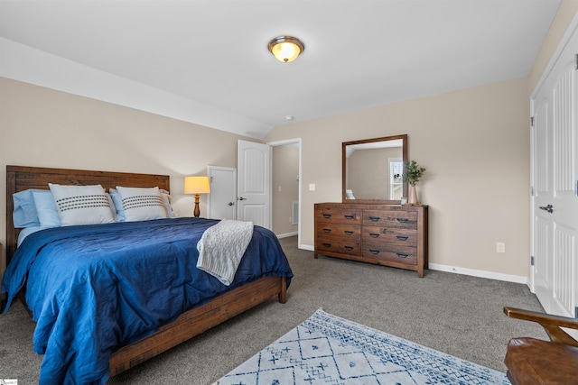 bedroom with baseboards, lofted ceiling, and carpet flooring